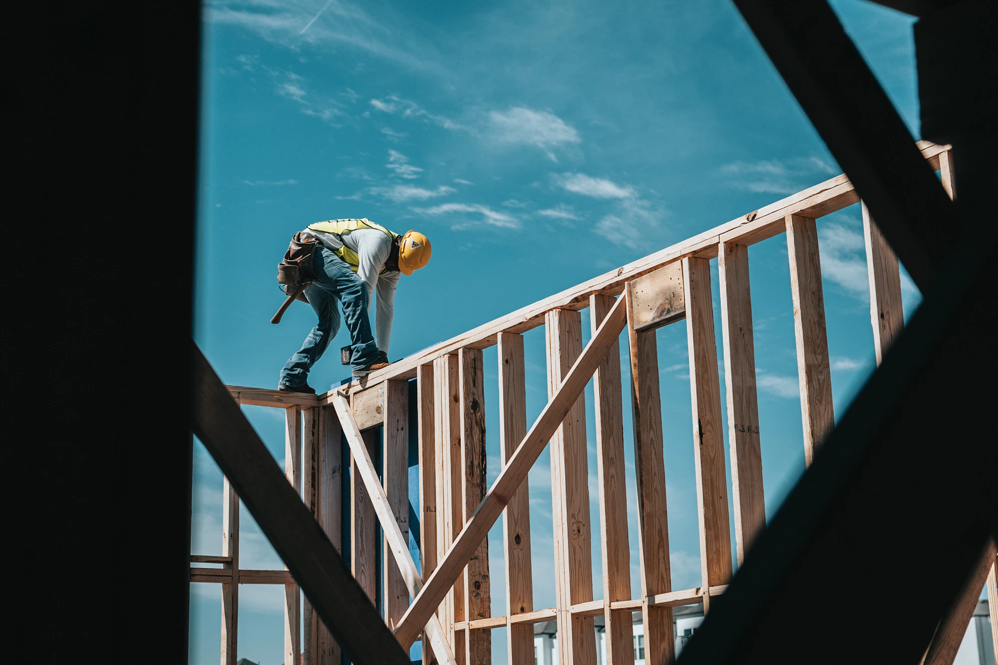 Construction worker in a hard hat on a Houston building frame