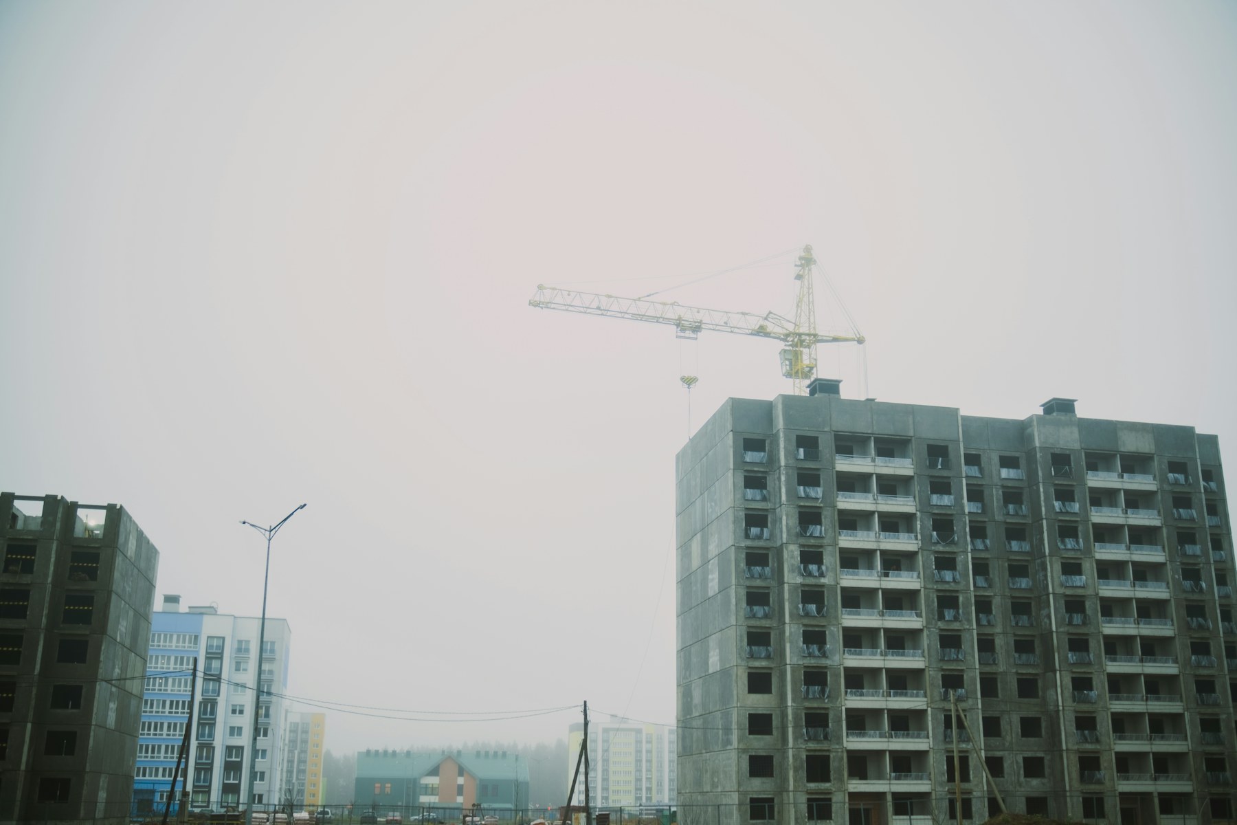 Tower crane beside an unfinished apartment building